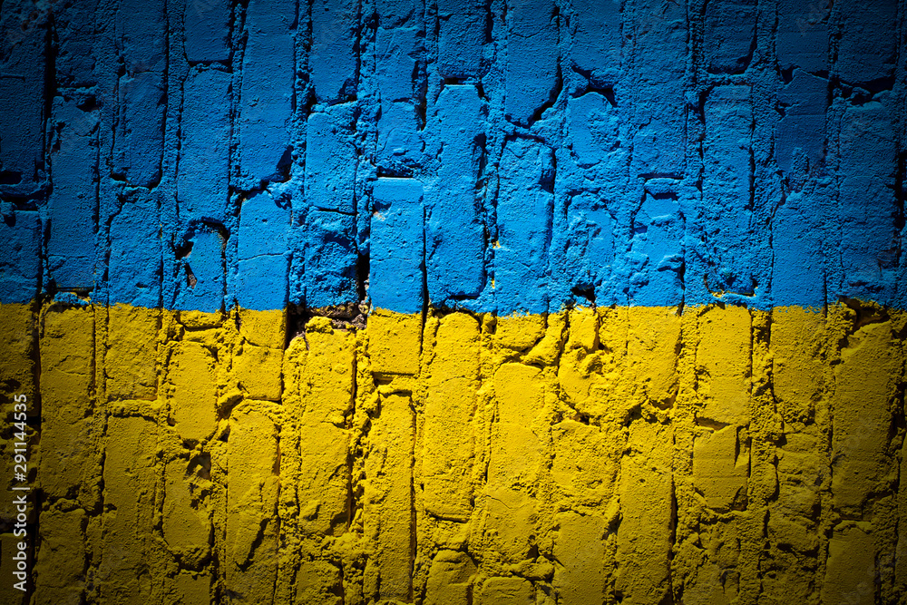 Flag of Ukraine painted on brick wall, background texture