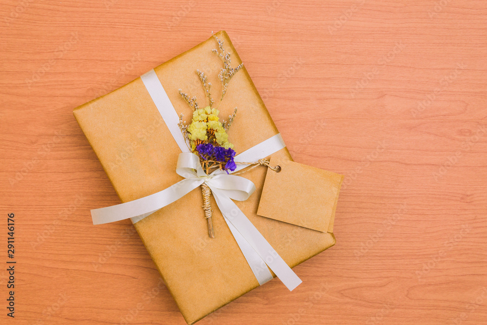 gift box with white ribbon and bow on wooden background gift box with white ribbon and bow on wooden background