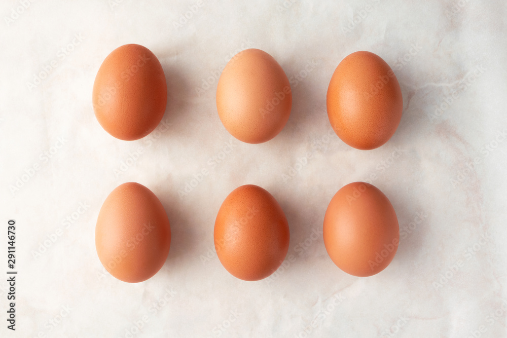 Brown organic eggs on marble background, top view. Easter minimalism concept Brown organic eggs on marble background, top view. Easter minimalism concept