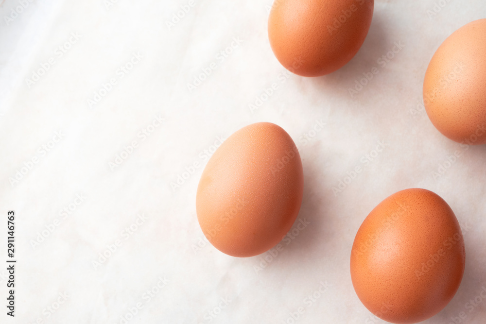 Close-up organic eggs on marble background and copy space, above. Easter minimalism concept Close-up organic eggs on marble background and copy space, above. Easter minimalism concept