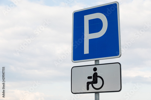 Roadsign Parking lot with white tablet for handicapped