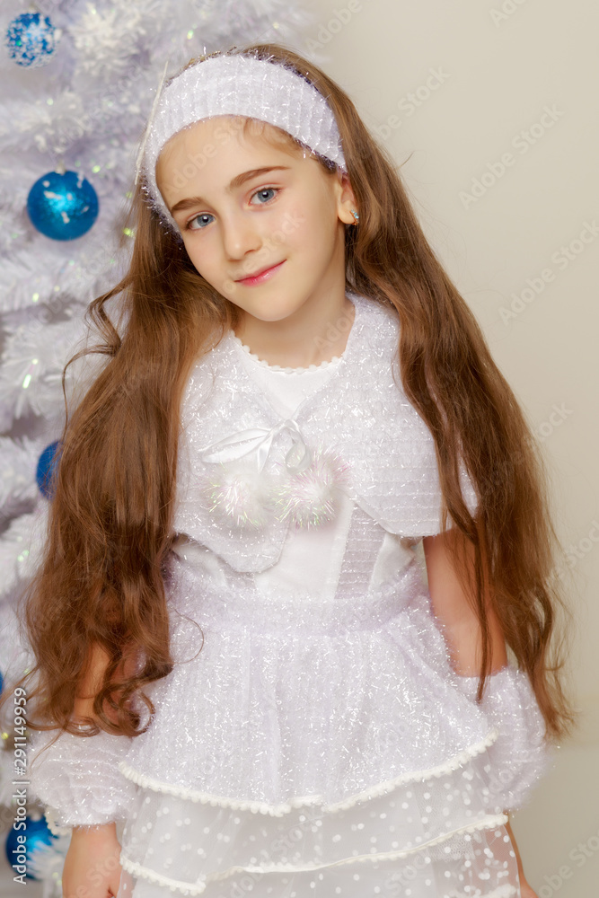 Beautiful little girl near the Christmas tree. Beautiful little girl near the Christmas tree.