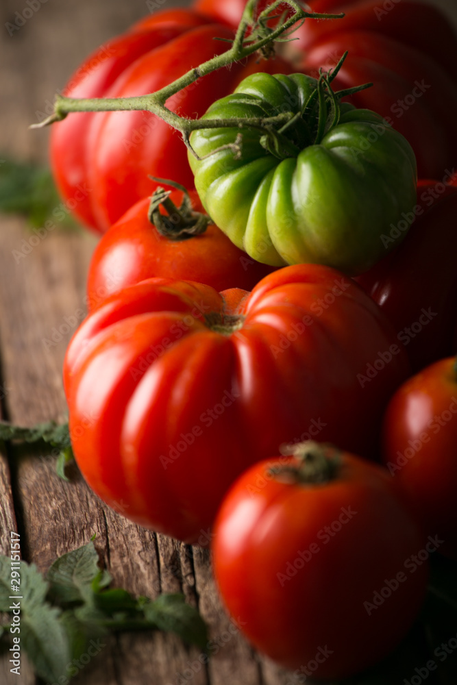 Fresh, ripe tomatoes on wood background.