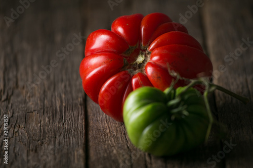 Fresh, ripe tomatoes on wood background.