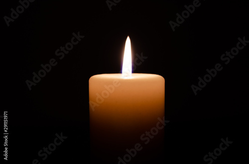 Candle lit on black background