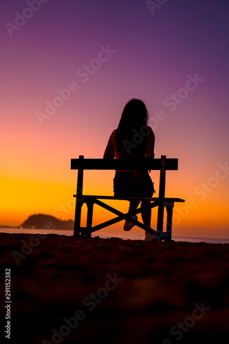 Lifestyle, a girl a chair in a beautiful purple sunset, vertical photography