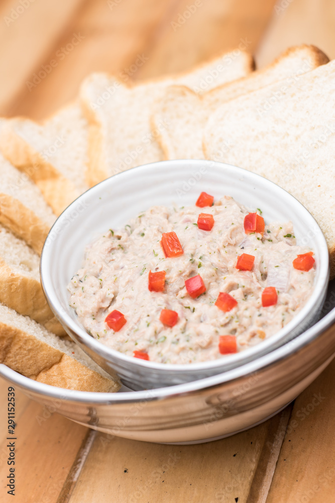Tuna dip with bread and paprika on a wooden table Tuna dip with bread and paprika on a wooden table