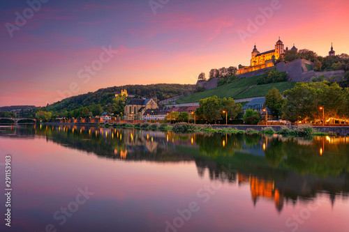 Wurzburg, Germany. Cityscape image of Wurzburg with Marienberg Fortress and reflection of the city in Main Rive during beautiful sunset.