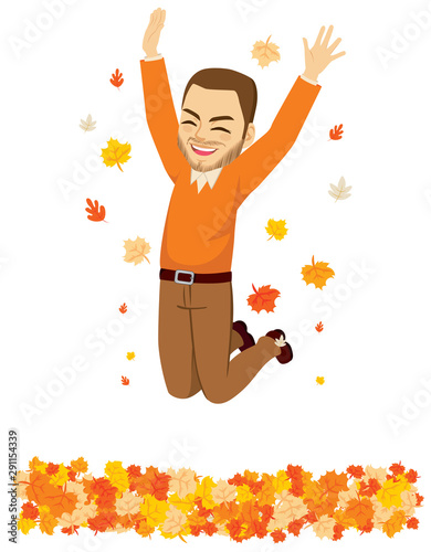 Happy autumn time man jumping over fall leaves