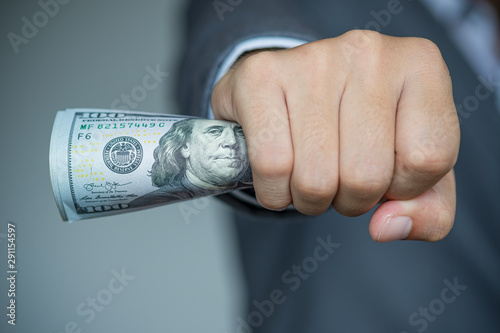 Businessman holding and give US dollar banknoted.US dollar is main and popular currency of exchange in the world.Investment and spayment concept. photo