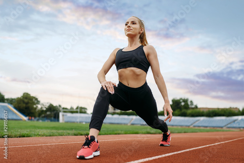 Female jogger in sportswear, training on stadium