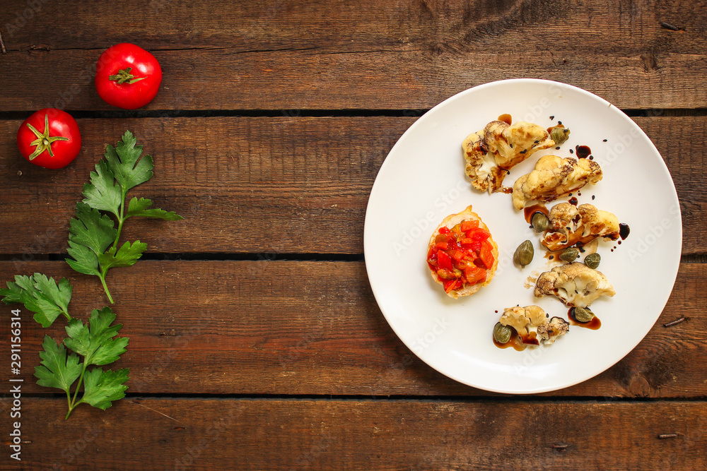 cauliflower grilled (fried grill vegetables or snack salad, bruschetta with tomato) menu concept. food background. copy space. Top view cauliflower grilled (fried grill vegetables or snack salad, bruschetta with tomato) menu concept. food background. copy space. Top view