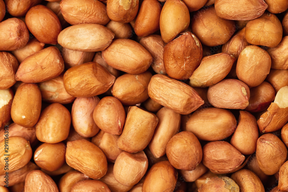 Macro flatlay image of unpeeled peanuts as a food background. Macro flatlay image of unpeeled peanuts as a food background.