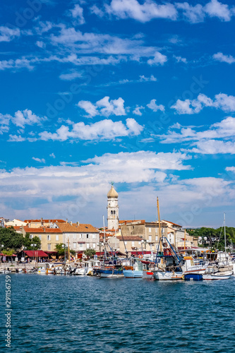 Panoramic view of Krk town with blue Adriatic Sea and boats on sunny summer day, Krk Island in Croatia