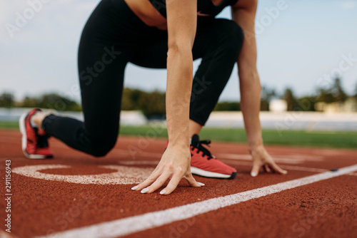 Female runner on start line, training on stadium