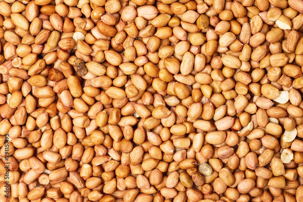 Closeup flatlay image of salted peanuts as a food background.