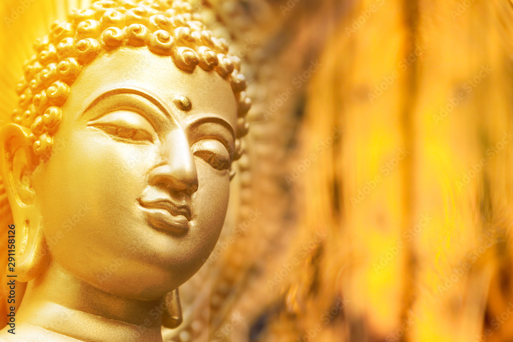 Buddha face on the golden backdrop