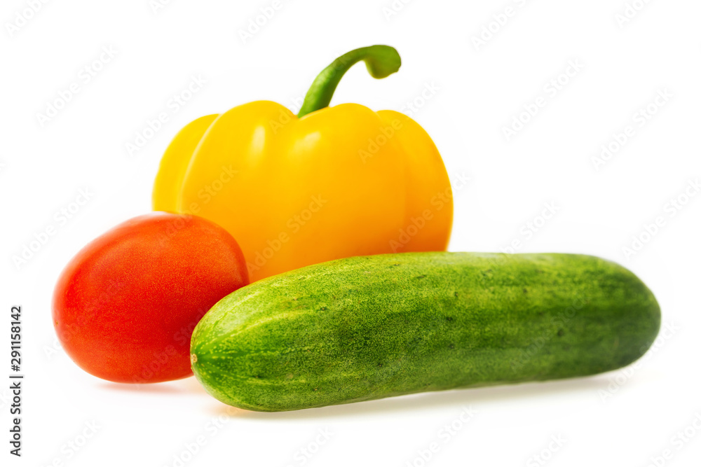 Closeup image of vegetables festive three colors group. Red tomato, green cucumber and yellow pepper isolated at white background. Closeup image of vegetables festive three colors group. Red tomato, green cucumber and yellow pepper isolated at white background.