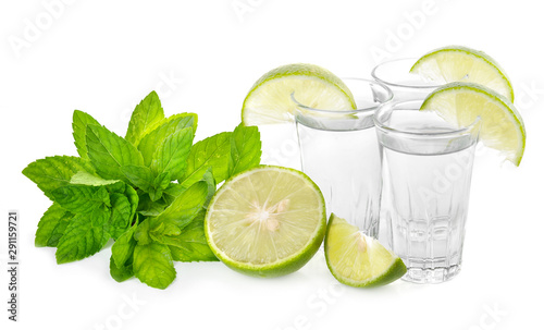 Tequila shot with juicy lime slice on white background © supia