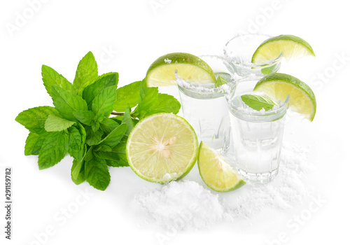Tequila shot with juicy lime slice on white background © supia