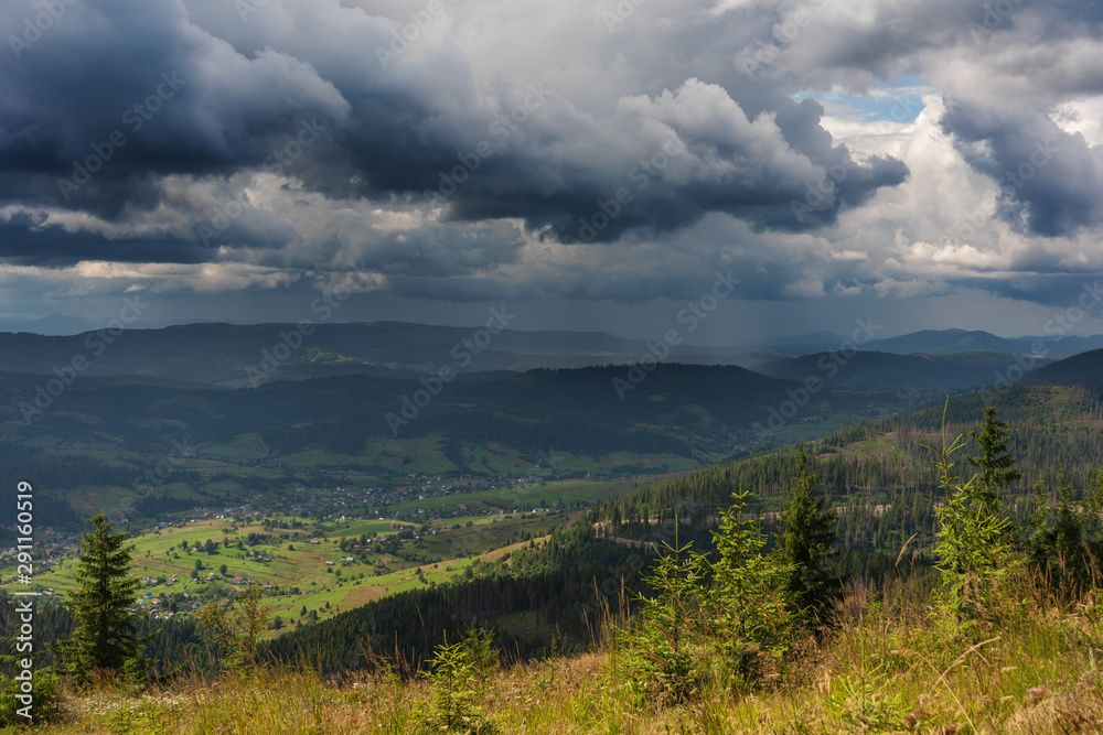 A wonderful walk along the ridge in the Ukrainian Carpathians amidst the scent of flowers, the dramatic cloudy sky before the rain with a thunderstorm.