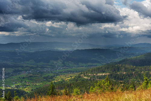 A wonderful walk along the ridge in the Ukrainian Carpathians amidst the scent of flowers  the dramatic cloudy sky before the rain with a thunderstorm.