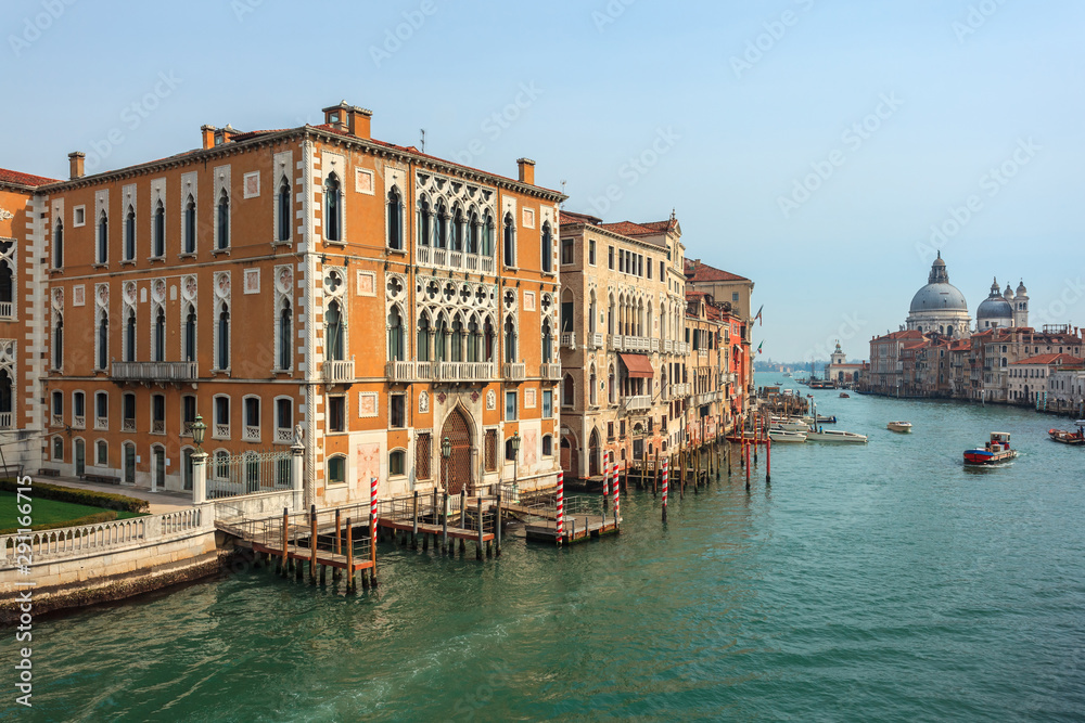 View of Canal Grande. Various boats float by a fine architectural complex of embankments.