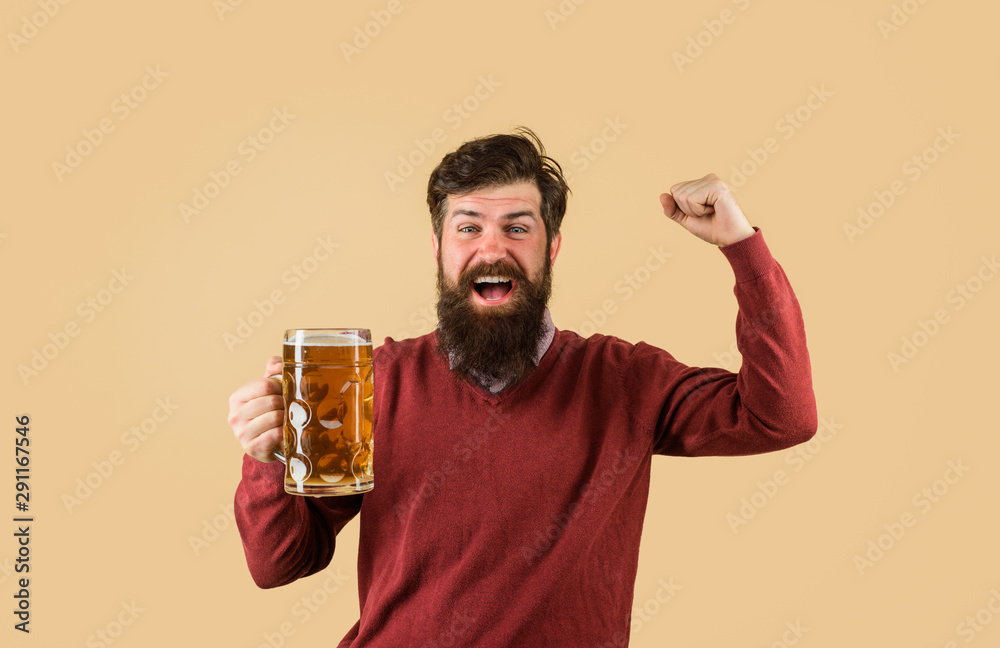 Bearded male tasting fresh brewed beer. Craft beer at restaurant. Drink, alcohol, leisure and people concept. Oktoberfest festival. Beer in Germany. Bearded man drinking beer from glass at bar or pub.