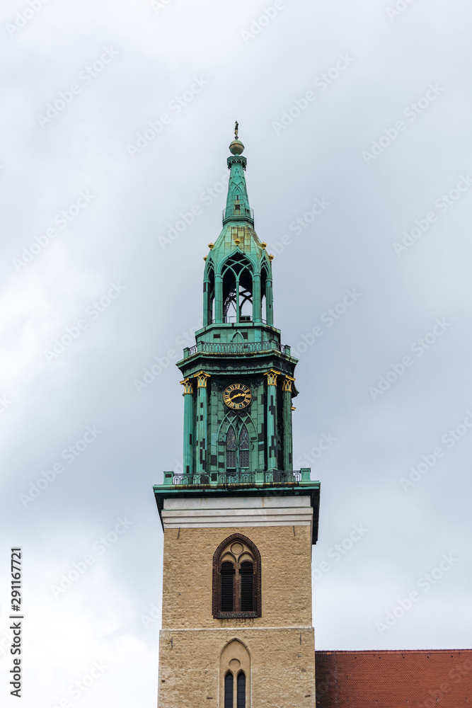  Bell Tower of St Mary's Church (Marienkirche) against cloudy sky. The church was originally a Roman Catholic church, but has been a Lutheran Protestant church since the Protestant Reformation.