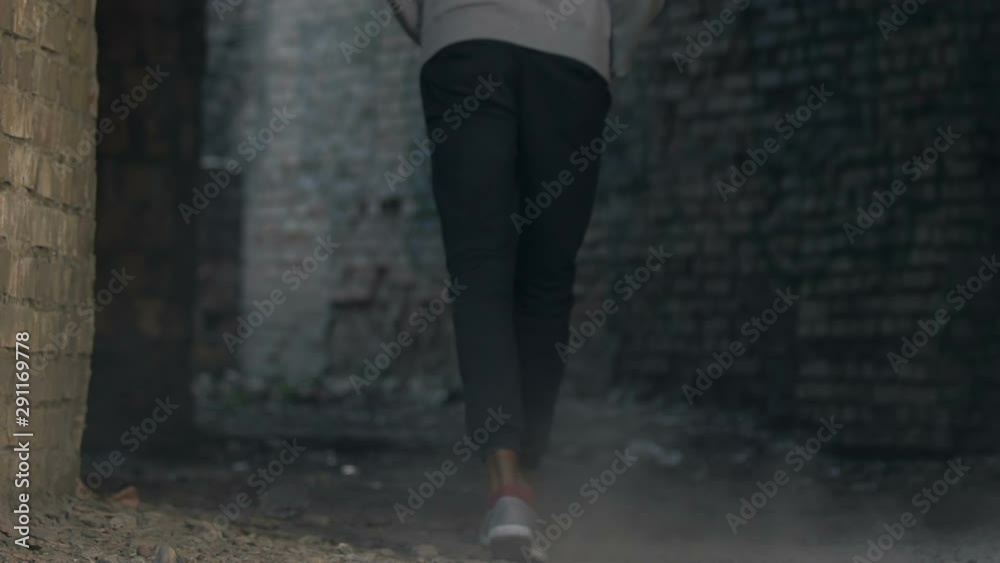 African american male teen strolling in abandoned building, loneliness concept African american male teen strolling in abandoned building, loneliness concept