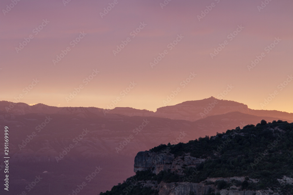 Sunset in the mountains with pink sky.