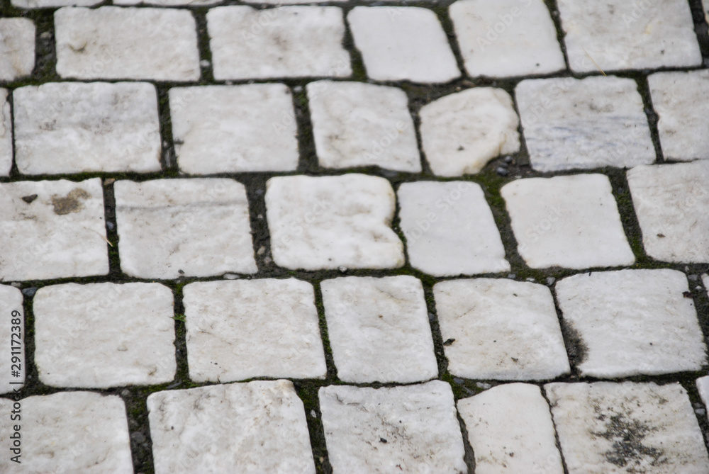 squares of marble on a sidewalk in a street