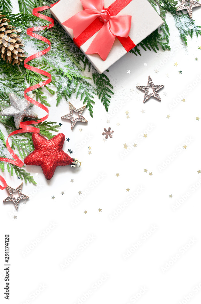Christmas background, green pine branches, cones and gift box on white background. Creative composition with copy space, top view. New Year's holiday, christmas.
