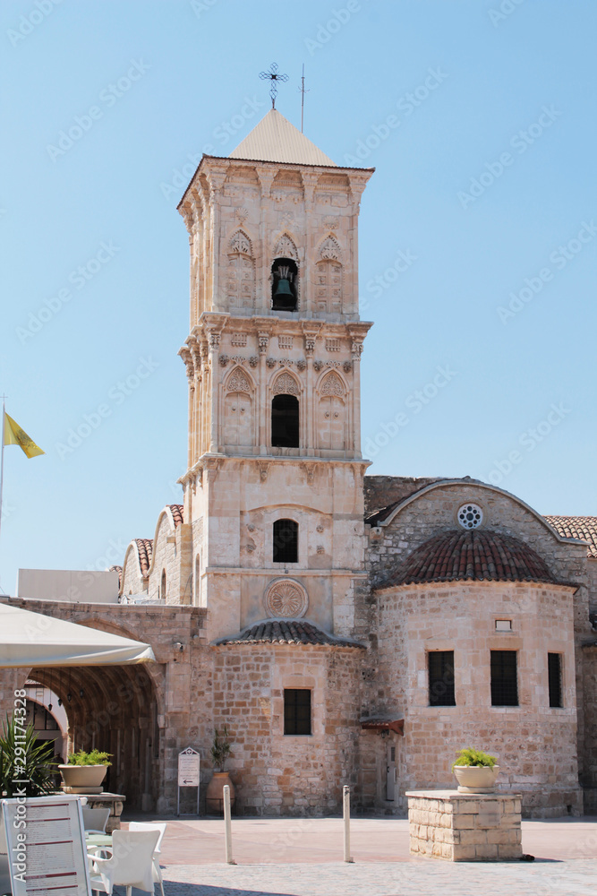 Obraz premium Church of St. Lazarus - front view. Tower with a bell and a cross, arched passage.