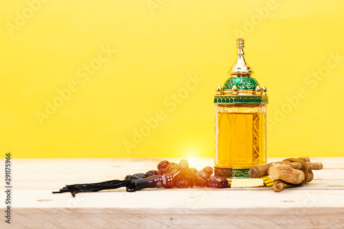 Ornamental Arabic lantern oud perfume with black rosary, siwak Ramadan Kareem Greeting Card. Ramadan Mubarak.
