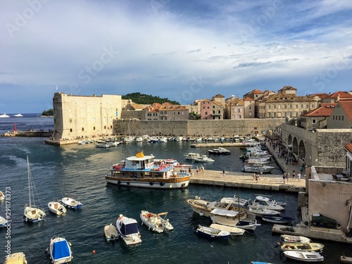 A view from outside the Walls of Dubrovnik looking at the bay full of boats and a long portion of the wall