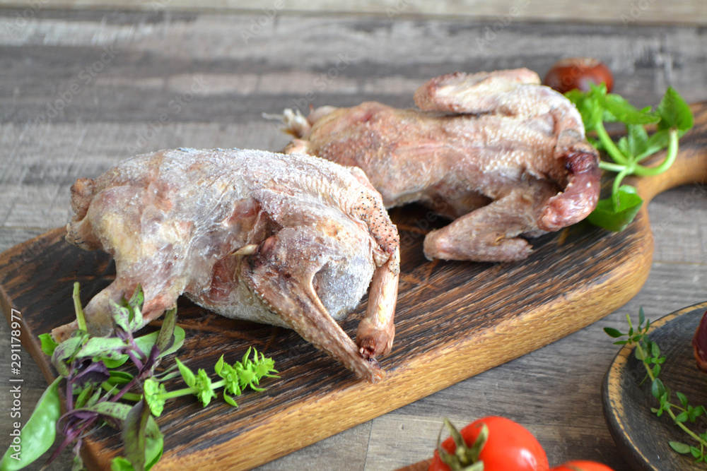 Wildfowl hunting. Two raw woodcock on rustic table, russian cuisine Wildfowl hunting. Two raw woodcock on rustic table, russian cuisine
