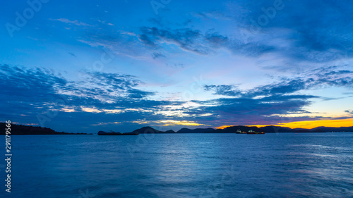 Beautiful sunset during twighlight time with clouds,Blue sky and mountain around the sea at sattahip,pattaya,chonburi,Thailand