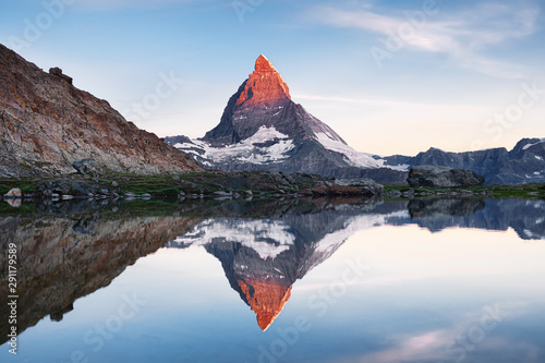 Платно Matterhorn and reflection on the water surface during sunrise