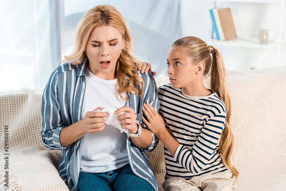 cute kid looking at sick mother with tissue cute kid looking at sick mother with tissue