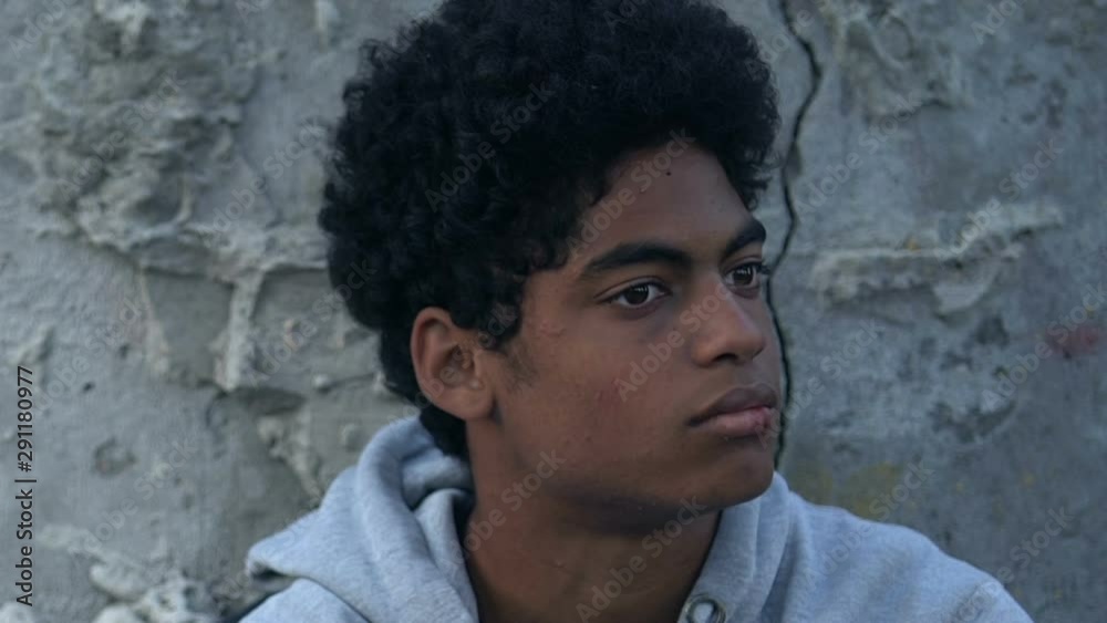 Mixed-race male teenager with bruised face, breathing to calm down, depression Mixed-race male teenager with bruised face, breathing to calm down, depression