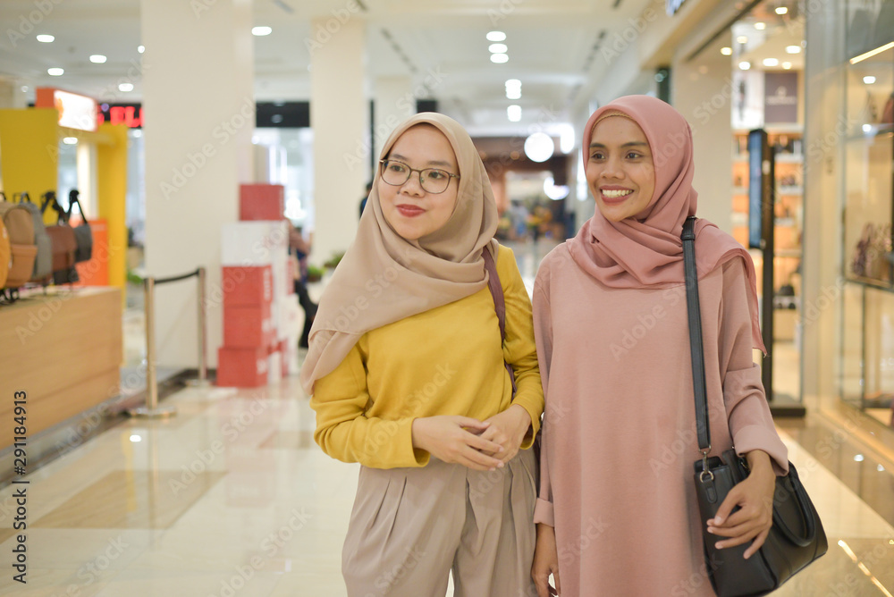 Portrait of two young asian muslim women shopping in mall Portrait of two young asian muslim women shopping in mall