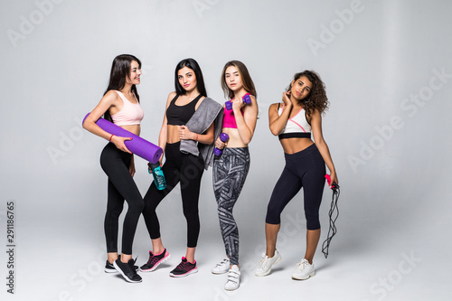 Four beauty women fitness holding different exercises equipment isolated on white background