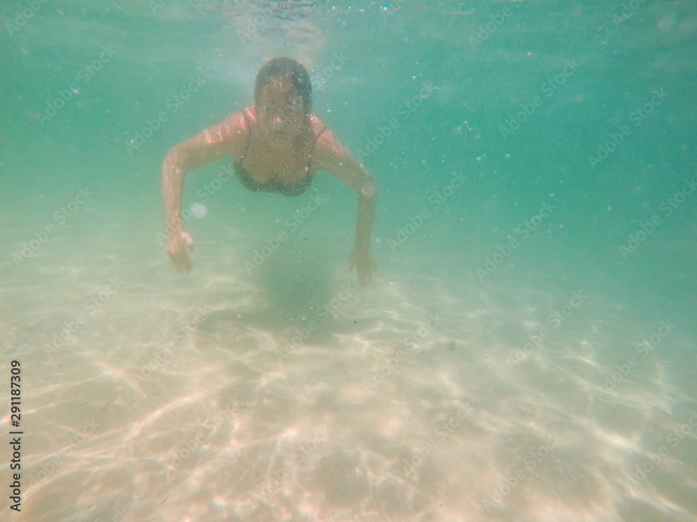 Underwater photo of woman swimming in the sea