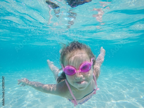 Happy child underwater portrait swimming and dive in the sea