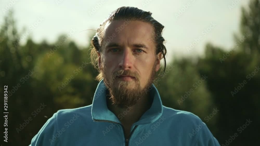 Close-up face of a mountain hiker man in the forest. Slow motion shooting. Close-up face of a mountain hiker man in the forest. Slow motion shooting.