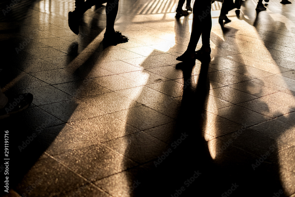 silhouette, Crowd of anonymous people walking on busy city street with ...