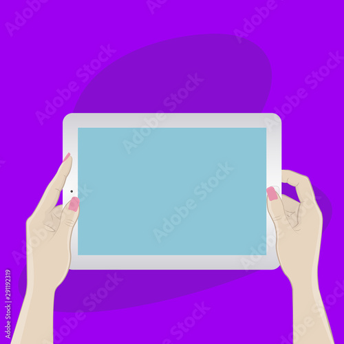 Digital tablet in hands on a purple background