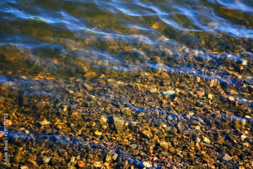 Texture of the surface of the water in the river on a sunny summer day.