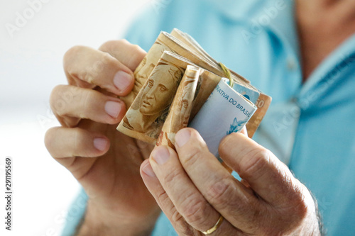 Hands holding Brazilian real notes - Money from Brazil - Notes of Real - Brazil BRL banknote